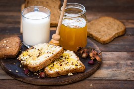 Healthy breakfast – bread, butter and honey manuka honey on bread